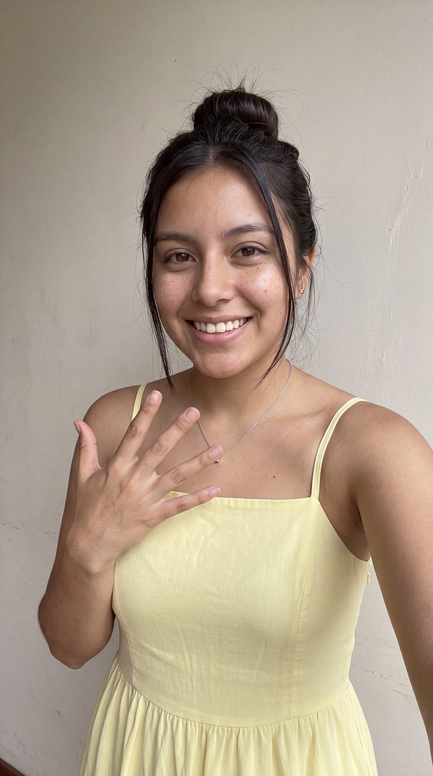 Laura smiling in a yellow sundress, a candid joyful moment